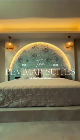 Hotel bedroom featuring a circular illuminated headboard and a bed, with the 'The Bevimar Suites' logo and 'Est 2026' on the wall.