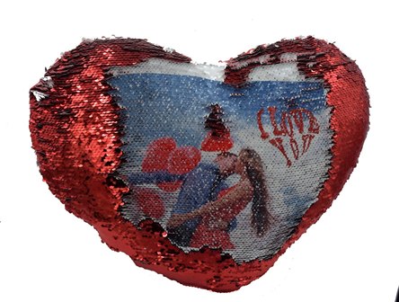 Heart-shaped red sequin ornament showing a beach photo of a couple visible behind the sequins