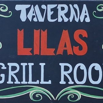 Signboard for a tavern: text reads 'Taverna Lilas Grill Room' on a dark blue background with green decorative swirls.